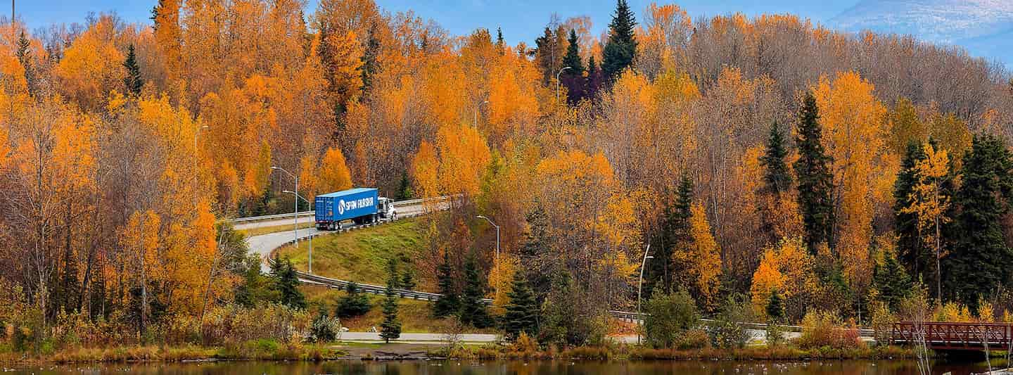 Span Alaska truck driving through Alaska during the fall