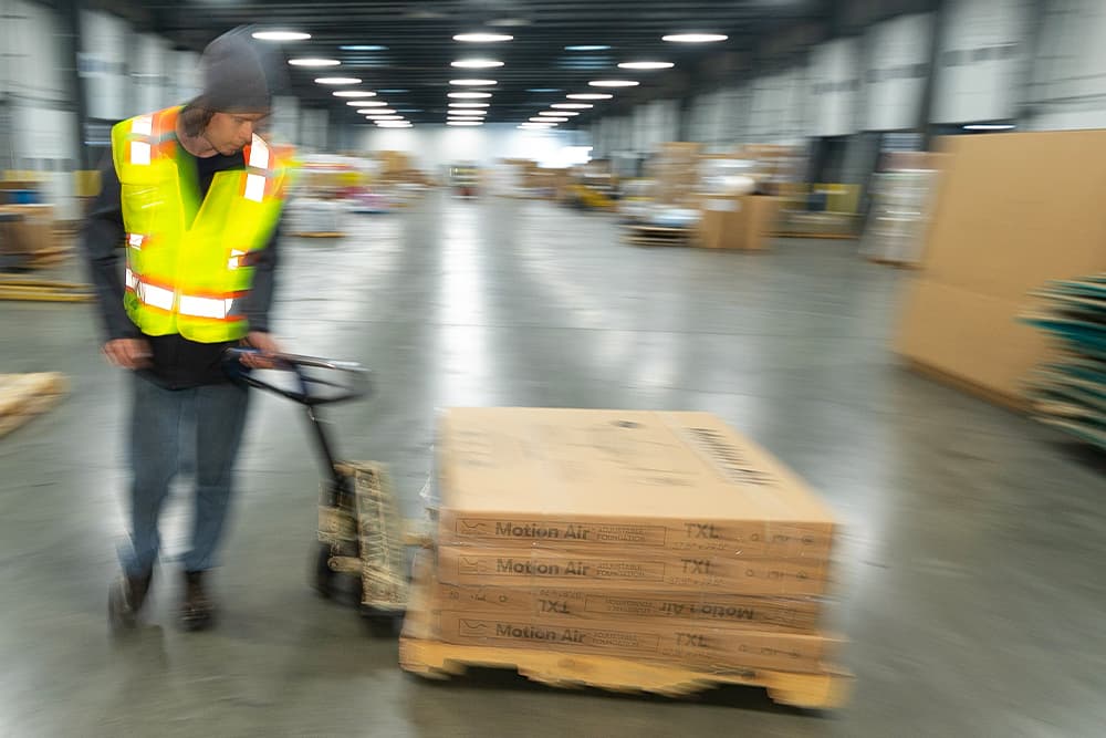 warehouse team member in action moving pallet