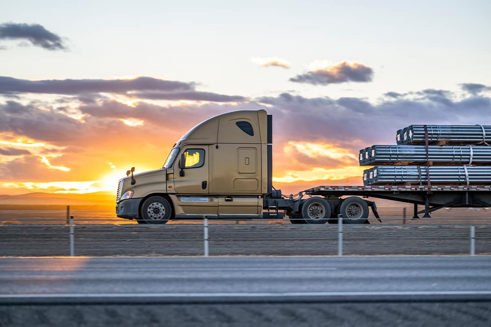 flatbed transporting long pipes