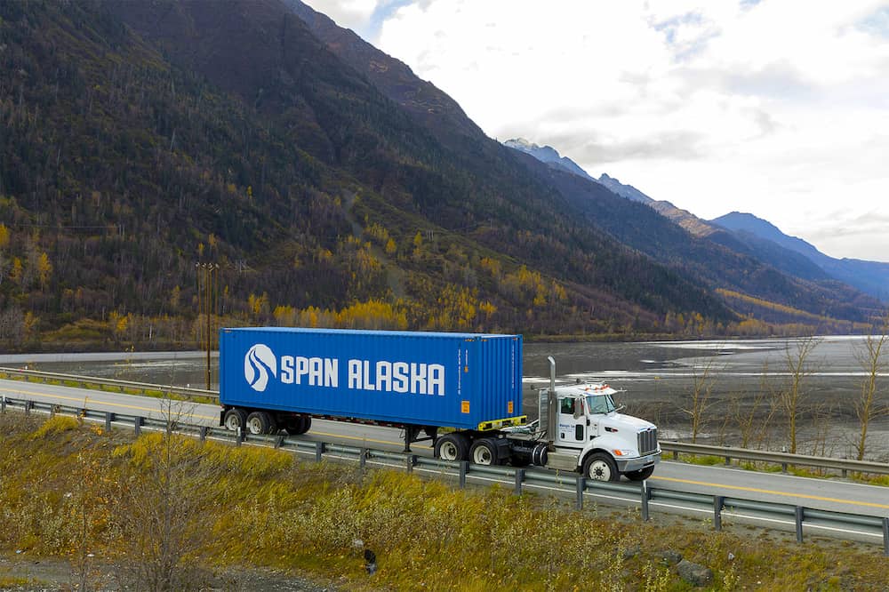 Span Alaska truck driving past water