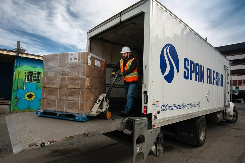 man loading cargo into Span Alaska truck