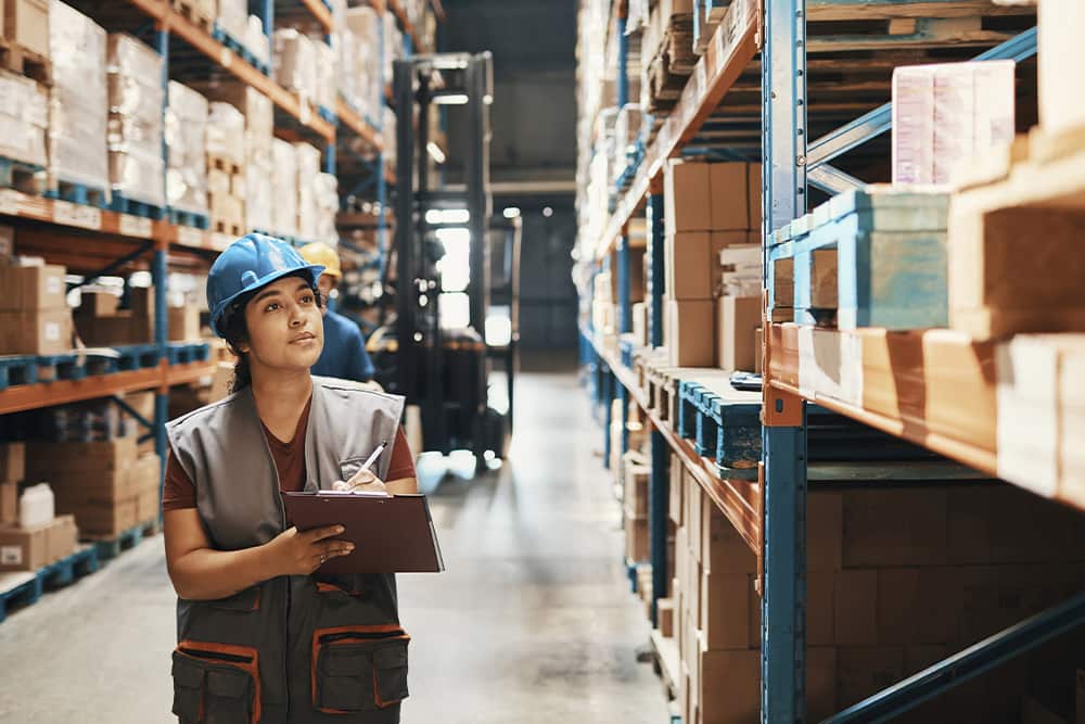 woman in warehouse tracking cargo